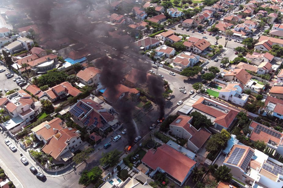 Vehicles in Ashkelon burn as rockets are launched from Gaza on October 7.