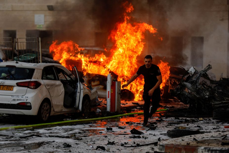 A man in Ashkelon runs after rockets were launched from Gaza on October 7.