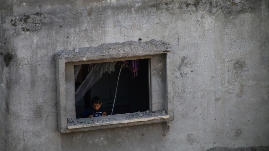 Palestinian citizens inspect damage to their homes caused by Israeli airstrikes in Gaza City on October 8.