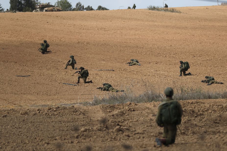 Israeli soldiers take position in Kfar Aza near the border with Gaza on October 10.