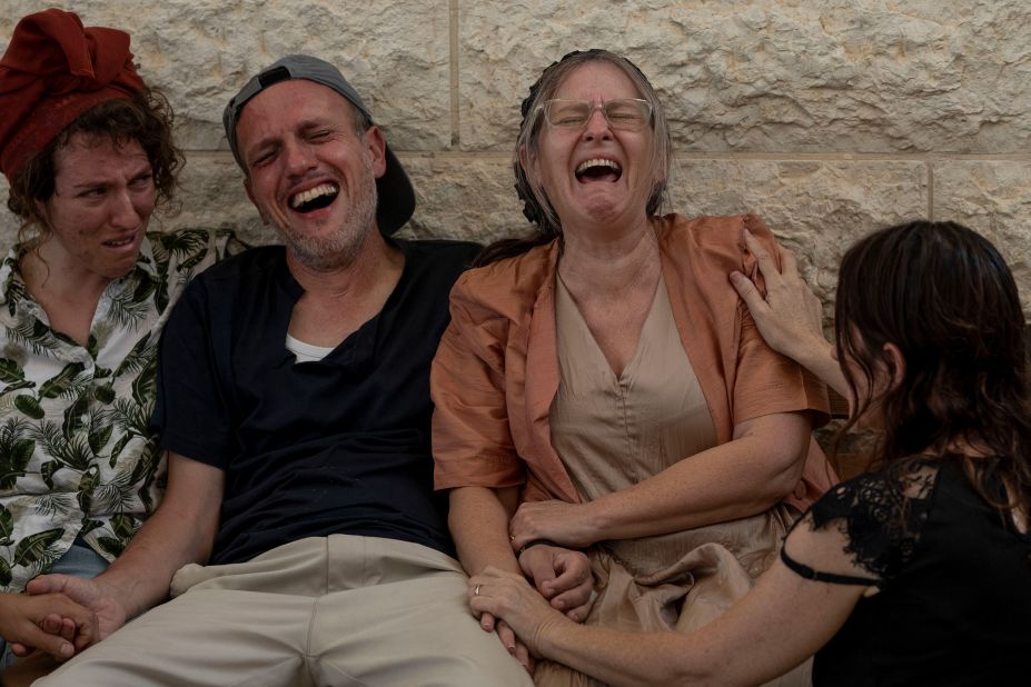 Itzik and Miriam Shafir, center, mourn during their son's funeral at a cemetery in Modiin Maccabim, Israel, on Wednesday, October 11. Their son, Dor Shafir, and his girlfriend, Savion Kiper, were killed during <a href="https://www.cnn.com/2023/10/07/middleeast/israel-gaza-fighting-hamas-attack-music-festival-intl-hnk/index.html" target="_blank">Hamas' attack on a music festival</a> on Saturday.