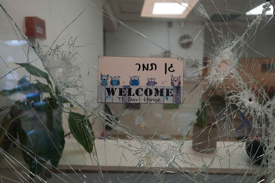 Bullet holes are seen in a cracked window at the entrance of a kindergarten in Be'eri, Israel, on October 11. The self-sustaining farming community near Gaza was <a href="https://www.cnn.com/2023/10/10/middleeast/israel-beeri-bodies-found-idf-intl-hnk/index.html" target="_blank">one of the first places targeted by Hamas militants</a> on October 7.