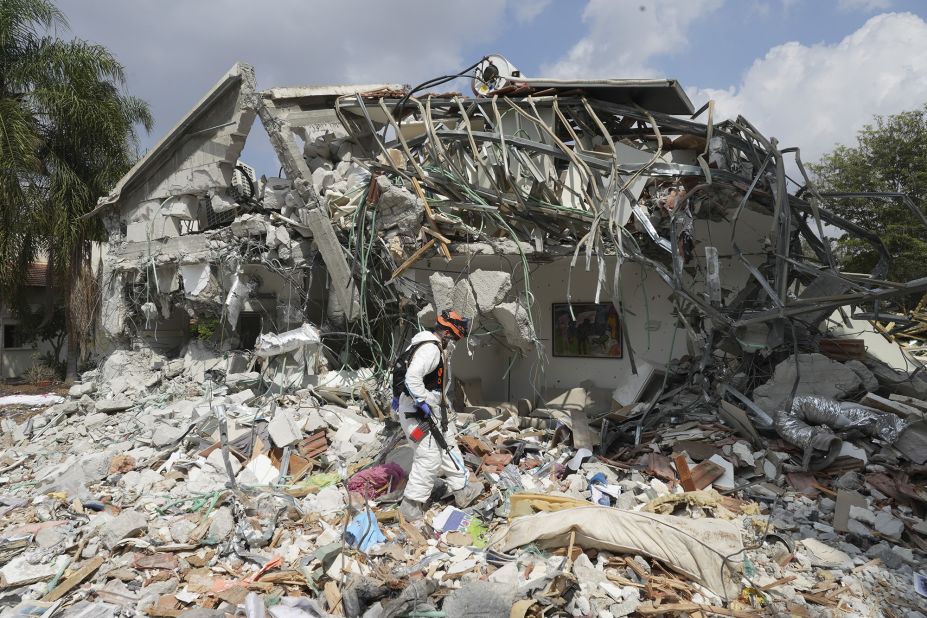 An Israeli soldier walks by a house destroyed by Hamas militants in Kibbutz Be'eri on October 11.