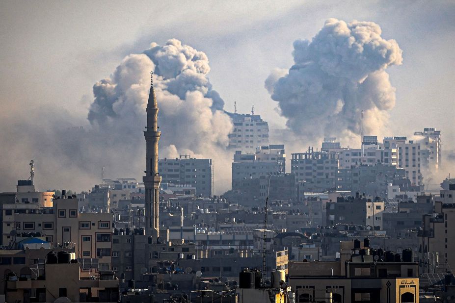 Smoke plumes billow during Israeli air strikes in Gaza City on October 12