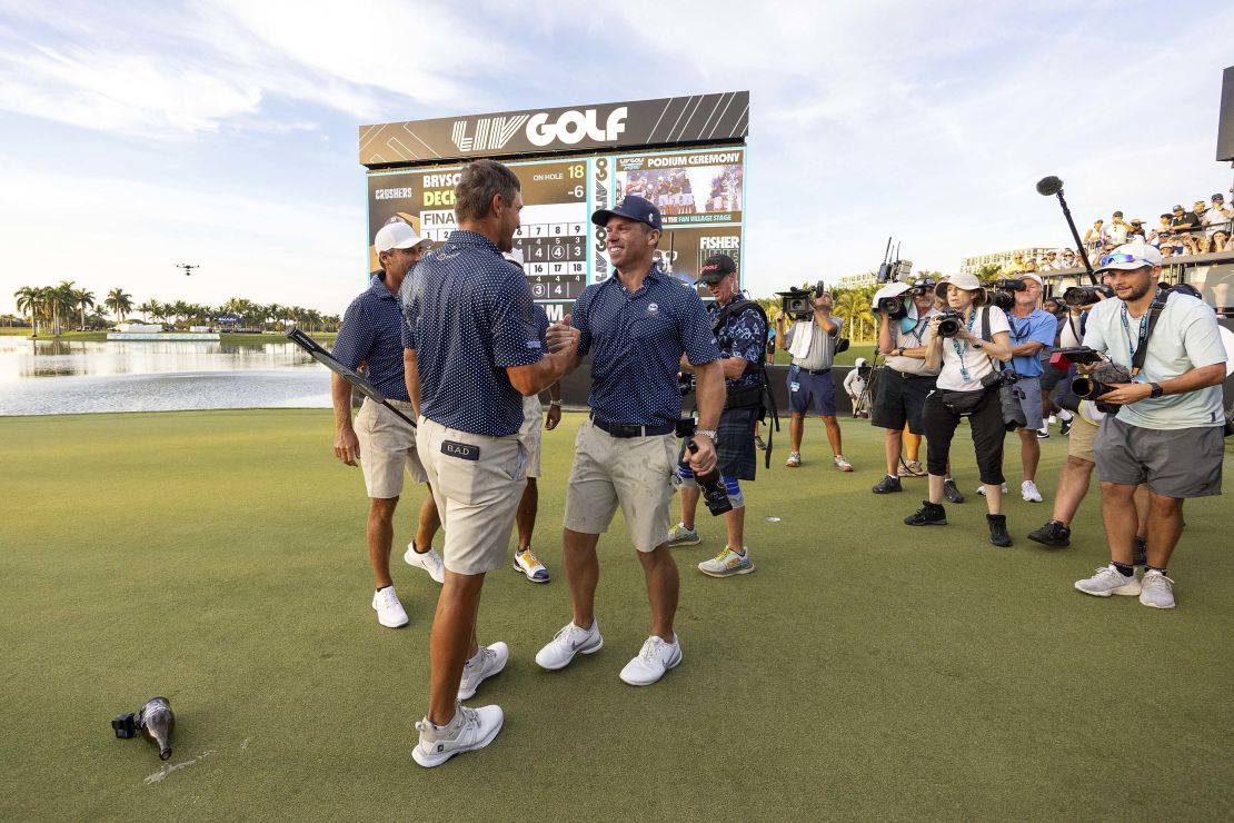 2023 Team Champions Captain Bryson DeChambeau and Paul Casey of Crushers GC shake hands as they celebrate with teammate Charles Howell III and Anirban Lahiri on the 18th green after the finals of the LIV Golf Team Championship Miami at the Trump National Doral on Sunday, October 22, 2023 in Miami, Florida. (Photo by Chris Trotman/LIV Golf via AP)