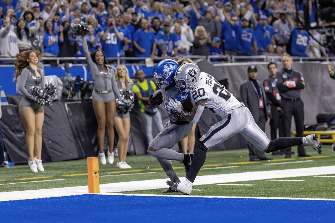 Oct 30, 2023; Detroit, Michigan, USA; Detroit Lions running back Jahmyr Gibbs (26) runs with the ball for a touchdown as Las Vegas Raiders safety Isaiah Pola-Mao (20) chases during the second half at Ford Field. Mandatory Credit: David Reginek-USA TODAY Sports