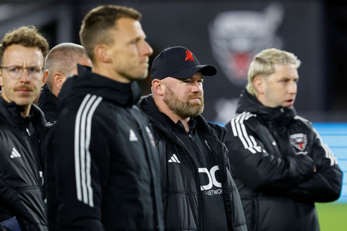 Oct 7, 2023; Washington, District of Columbia, USA; D.C. United head coach Wayne Rooney (M) looks on with his staff as his players salute their supporters after the match against New York City FC at Audi Field. Mandatory Credit: Geoff Burke-USA TODAY Sports