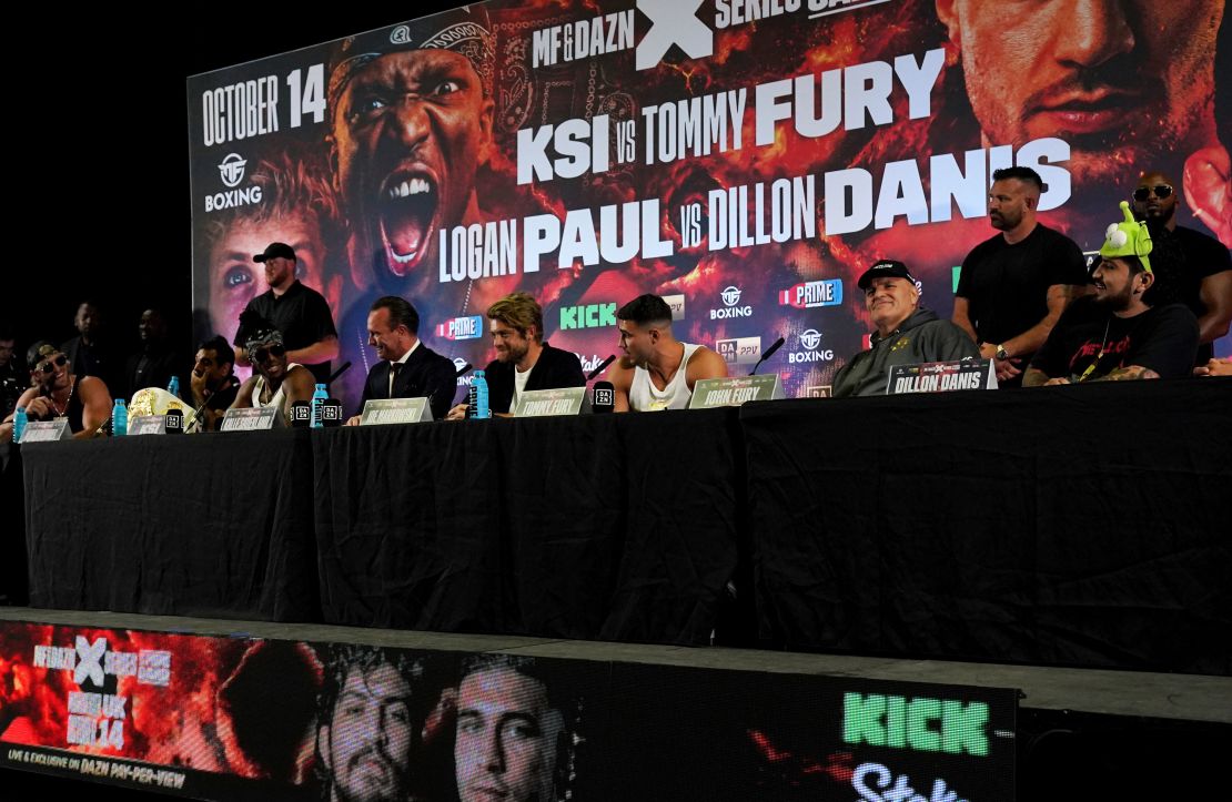 Left to right, Jake Paul, KSI, boxing promoter Kalle Sauerland, Joe Markowski, Tommy Fury, John Fury and Dillon Danis during a press conference at the OVO Arena Wembley, London. Picture date: Tuesday August 22, 2023. 73419020 (Press Association via AP Images)