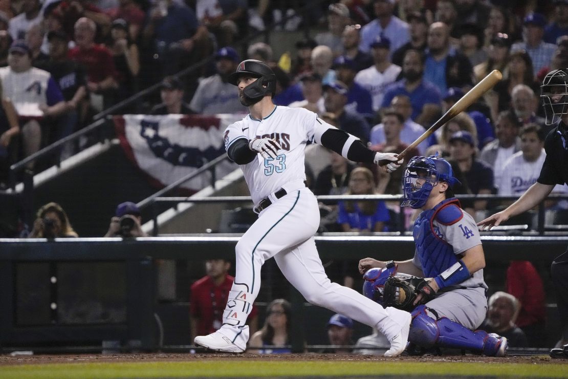 Arizona Diamondbacks' Christian Walker watches his home run during the third inning in Game 3 of a baseball NL Division Series against the Los Angeles Dodgers, Wednesday, Oct. 11, 2023, in Phoenix. (AP Photo/Rick Scuteri)