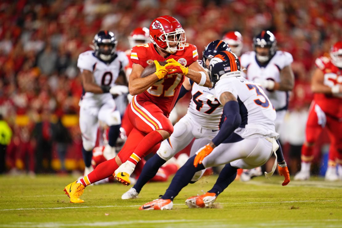 Travis Kelce #87 of the Kansas City Chiefs carries the ball against the Denver Broncos at GEHA Field at Arrowhead Stadium on October 12, 2023 in Kansas City, Missouri.