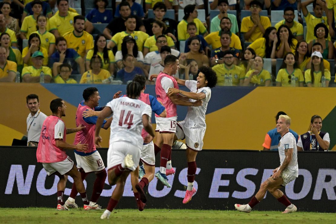 CUIABA, BRAZIL - OCTOBER 12: Eduard Bello (C) of Venezuela celebrates with teammates after scoring the first goal of their team during a FIFA World Cup 2026 Qualifier match between Brazil and Venezuela at Arena Pantanal on October 12, 2023 in Cuiaba, Brazil. (Photo by Pedro Vilela/Getty Images)