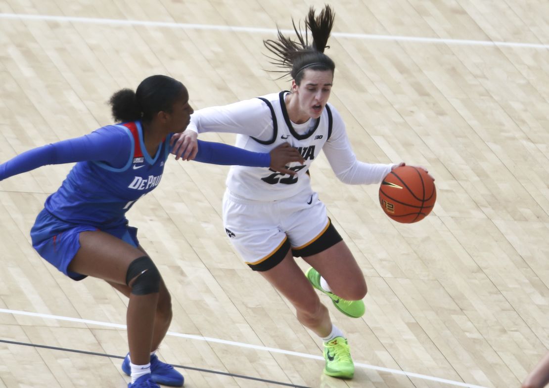 IOWA CITY, IOWA- OCTOBER 15:  Guard Caitlin Clark #22 of the Iowa Hawkeyes drives to the basket during the first half against guard Sumer Lee #11 of the DePaul Blue Demons at Kinnick Stadium during the Crossover at Kinnick event on October 15, 2023 in Iowa City, Iowa.  (Photo by Matthew Holst/Getty Images)