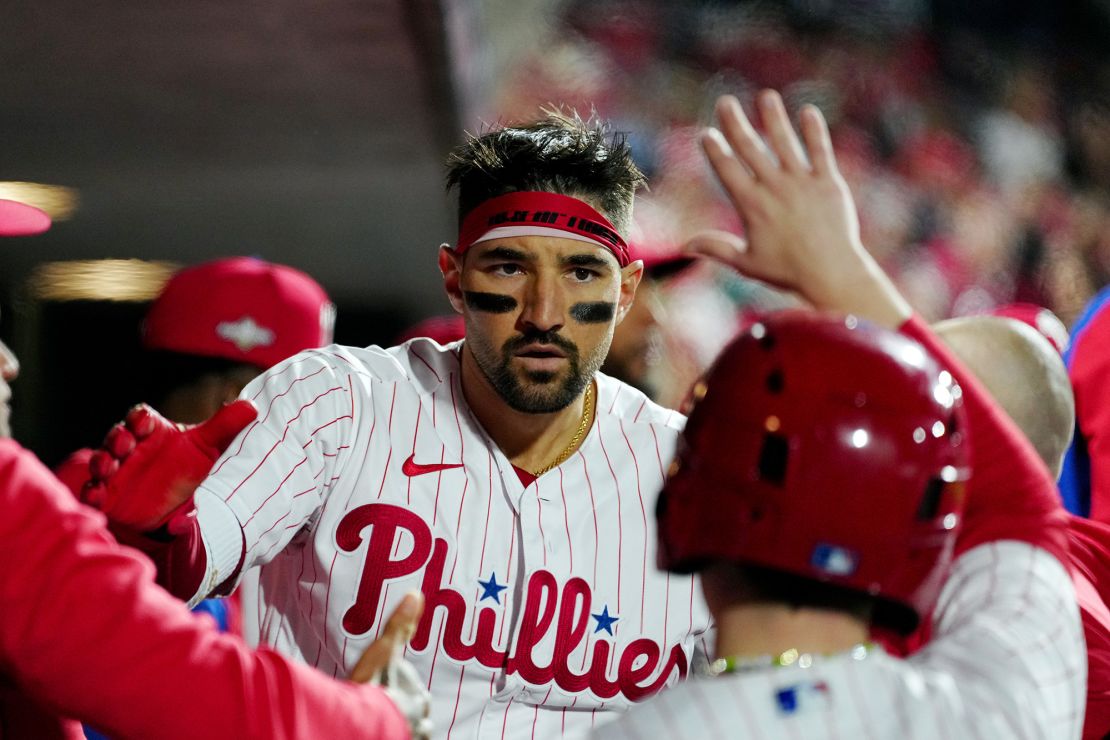 PHILADELPHIA, PA - OCTOBER 16:  Nick Castellanos #8 of the Philadelphia Phillies celebrates in the dugout with teammates after hitting a solo home run in the second inning during Game 1 of the NLCS between the Arizona Diamondbacks and the Philadelphia Phillies at Citizens Bank Park on Monday, October 16, 2023 in Philadelphia, Pennsylvania. (Photo by Mary DeCicco/MLB Photos via Getty Images)