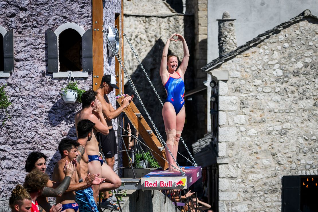 In this handout image provided by Red Bull, Molly Carlson of Canada acknowledges the crowd from the 21 metre platform on Stari Most (Old Bridge) during the second competition day of the fifth stop of the Red Bull Cliff Diving World Series on September 09, 2023 in Mostar, Bosnia and Herzegovina.