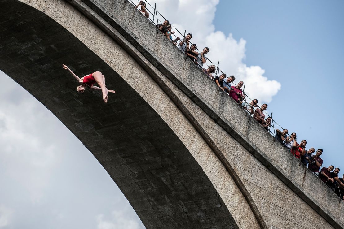 In this handout image provided by Red Bull, Molly Carlson of Canada dives from the 21 metre platform on Stari Most (Old Bridge) during the second competition day of the fifth stop of the Red Bull Cliff Diving World Series on August 26, 2022 in Mostar, Bosnia and Herzegovina.