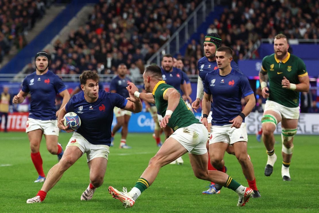 France's wing Damian Penaud (L) is tackled by South Africa's outside centre Jesse Kriel (C) during the France 2023 Rugby World Cup quarter-final match between France and South Africa at the Stade de France in Saint-Denis, on the outskirts of Paris, on October 15, 2023. (Photo by Emmanuel Dunand / AFP) (Photo by EMMANUEL DUNAND/AFP via Getty Images)