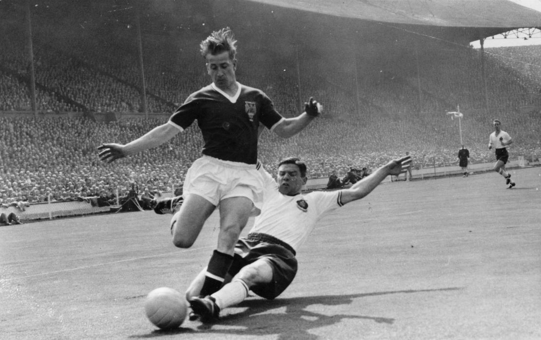 Manchester United's Bobby Charlton, being tackled by T Banks, the Bolton Wanderers left back, during the FA Cup Final at Wembley. Bolton won 2-0.