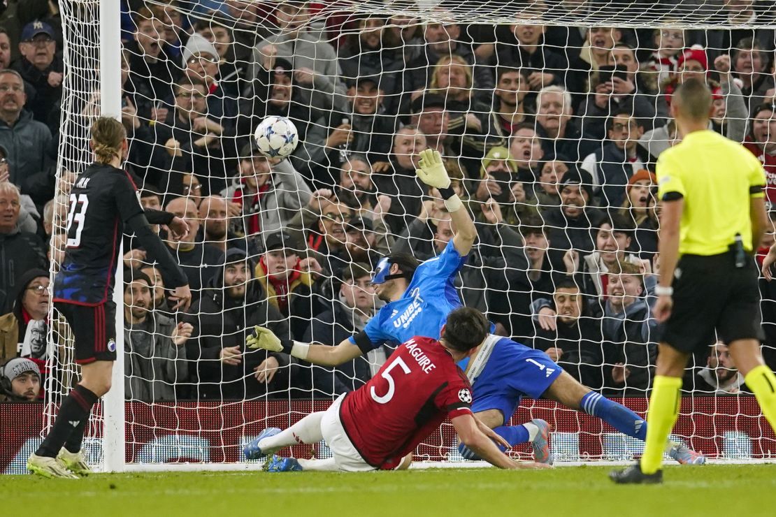 Manchester United's Harry Maguire, second left, scores his side's opening goal during the Champions League group A soccer match between Manchester United and Copenhagen at the Old Trafford stadium in Manchester, England, Tuesday, Oct. 24, 2023. (AP Photo/Dave Thompson)