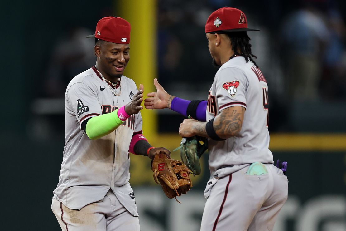 ARLINGTON, TEXAS - OCTOBER 28: Geraldo Perdomo #2 and Ketel Marte #4 of the Arizona Diamondbacks celebrate after beating the Texas Rangers 9-1 in Game Two of the World Series at Globe Life Field on October 28, 2023 in Arlington, Texas. (Photo by Jamie Squire/Getty Images)