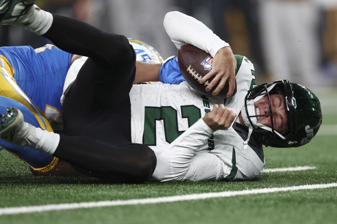 EAST RUTHERFORD, NEW JERSEY - NOVEMBER 06: Tuli Tuipulotu #45 of the Los Angeles Chargers sacks Zach Wilson #2 of the New York Jets during the fourth quarter at MetLife Stadium on November 06, 2023 in East Rutherford, New Jersey. (Photo by Elsa/Getty Images)