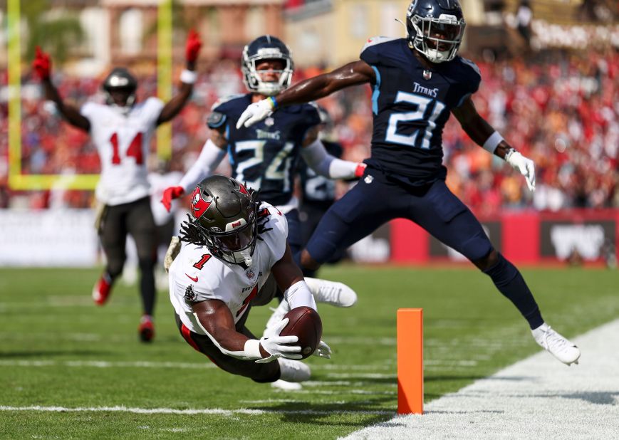 Rachaad White of the Tampa Bay Buccaneers dives into the end zone to score a touchdown during the Buccaneers' 20-6 victory over the Tennessee Titans.