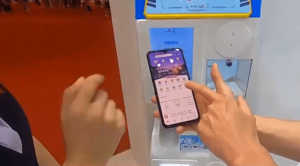 Visitors to a financial industry fair held in Zhenjiang’s Phoenix Cultural Plaza are shown how to use digital yuan wallets.