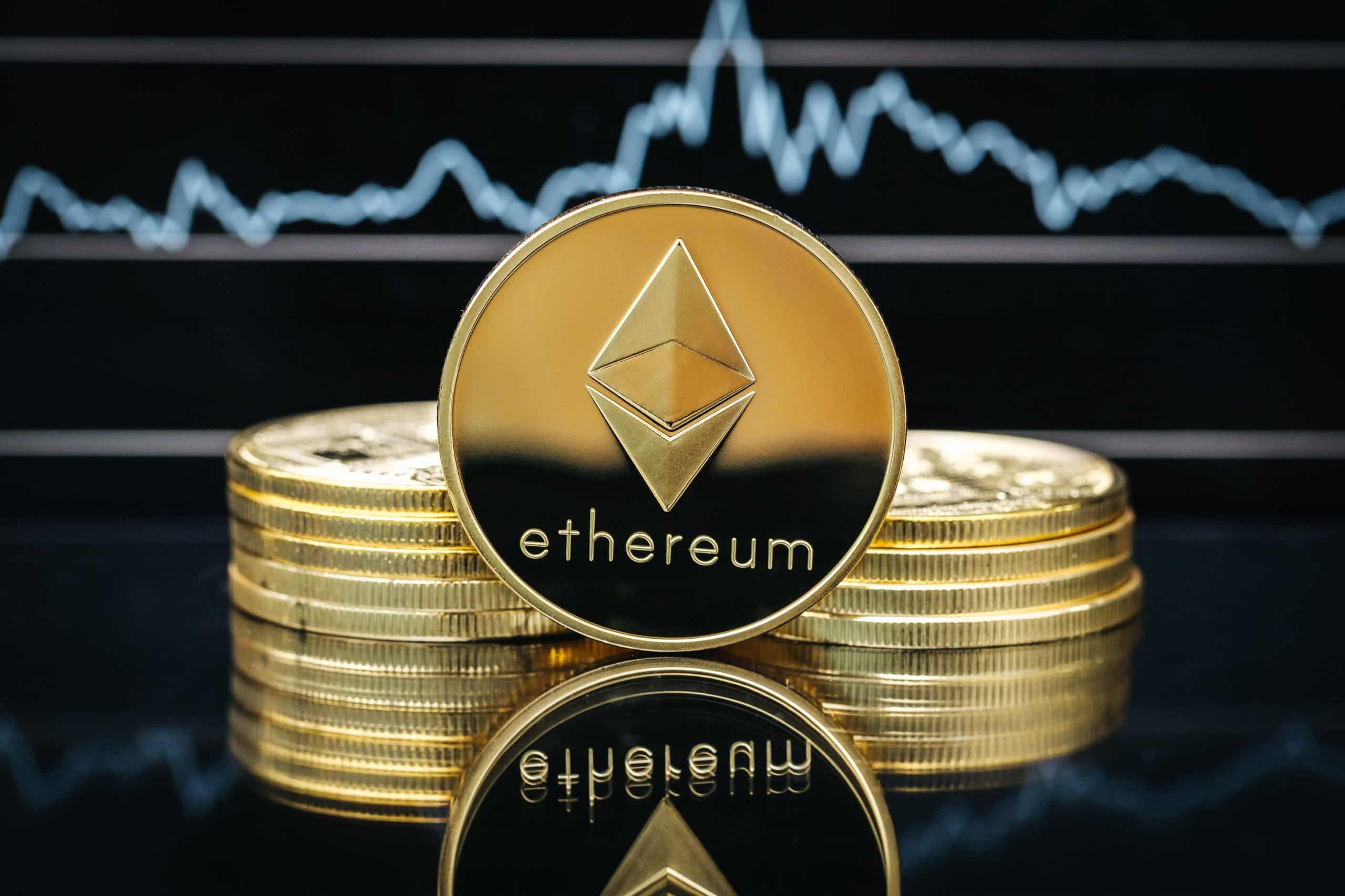 Ethereum cryptocurrency, physical coin close-up, in front of a price chart