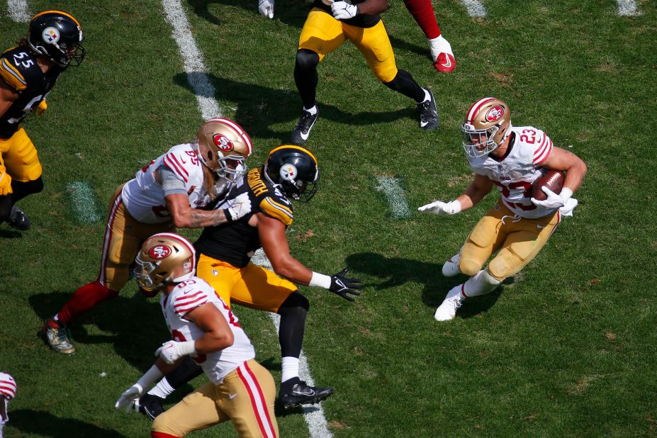 San Francisco 49ers running back Christian McCaffrey looks for space to run the ball in the second half of a 30-7 win over the Pittsburgh Steelers at Acrisure Stadium on September 10 in Pennsylvania.