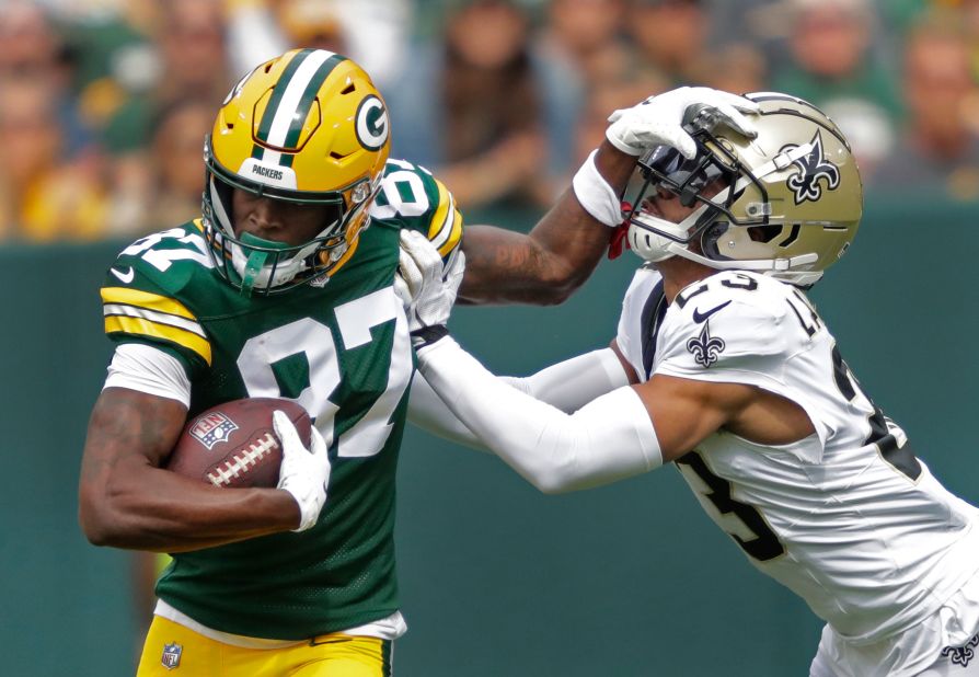 Green Bay Packers wide receiver Romeo Doubs fends off New Orleans Saints cornerback Isaac Yiadom during the first half at Lambeau Field. The Packers edged out a 18-17 win.