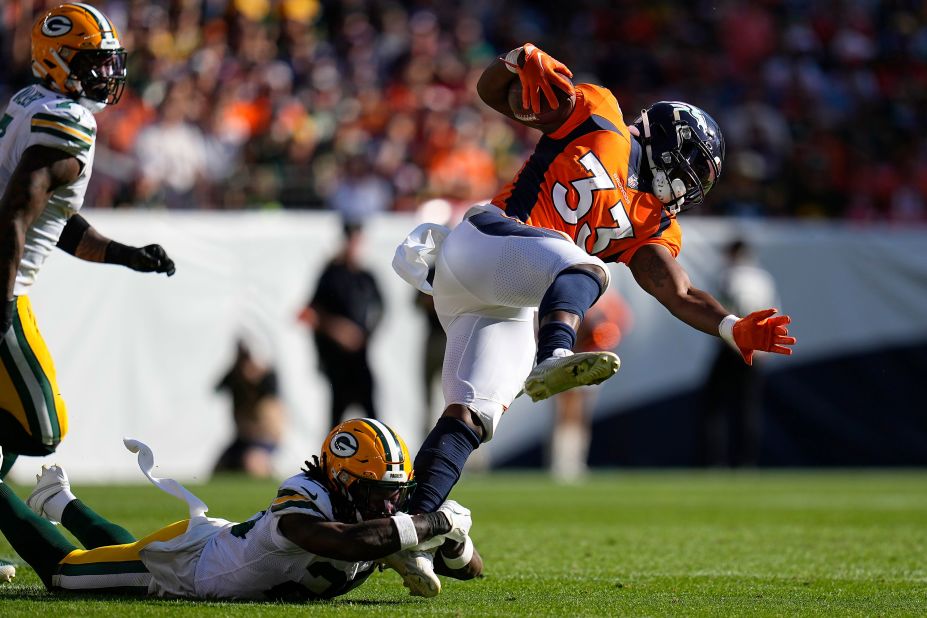 Denver Broncos running back Javonte Williams evades Green Bay Packers safety Darnell Savage, bottom. The Broncos beat the Packers 19-17.