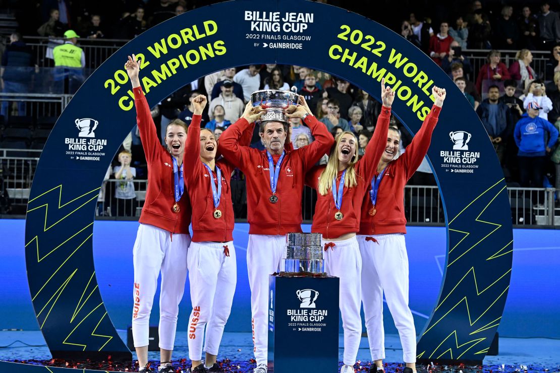 (L-R) Switzerland's Simona Waltert, Switzerland's Viktorija Golubic, Switzerland's captain Heinz Guenthardt, Switzerland's Jil Teichmann and Switzerland's Belinda Bencic celebrate with the trophy after Switzerland's victory over Australia in the final tennis match at The Billie Jean King Cup at The Emirates Arena in Glasgow on November 13, 2022. (Photo by Lesley Martin / AFP) (Photo by LESLEY MARTIN/AFP via Getty Images)