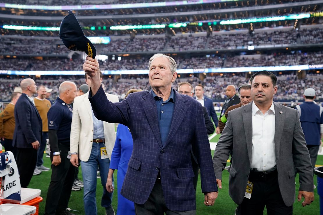 ARLINGTON, TEXAS - NOVEMBER 12: Former president George W. Bush waves to fans after the coin toss before the game between the New York Giants and Dallas Cowboys at AT&T Stadium on November 12, 2023 in Arlington, Texas. (Photo by Sam Hodde/Getty Images)