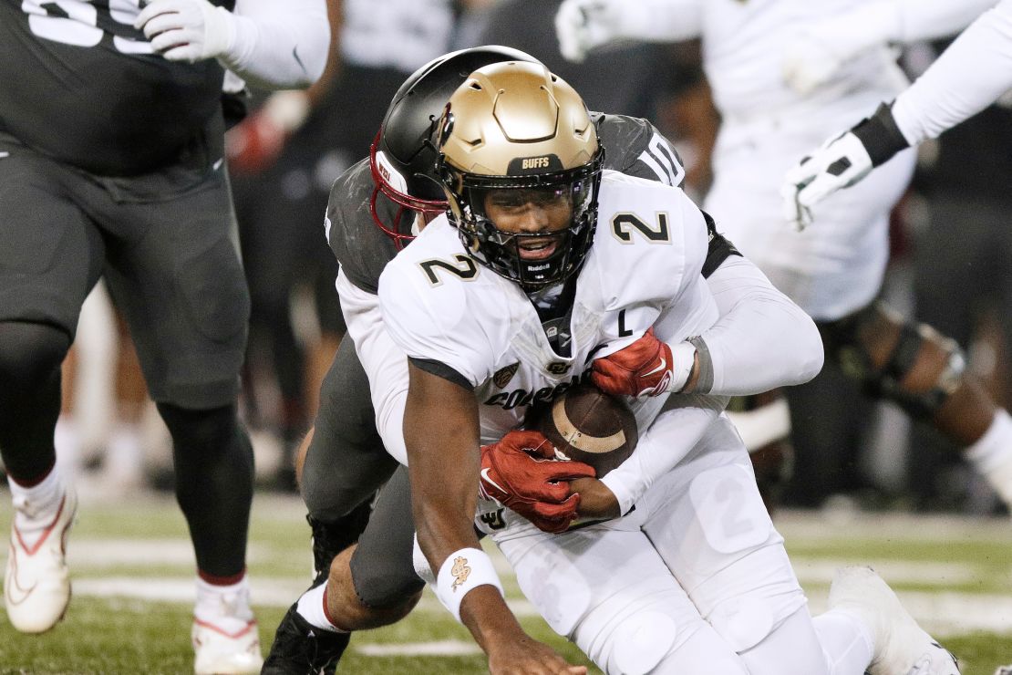 Washington State defensive end Ron Stone Jr. (10) sacks Colorado quarterback Shedeur Sanders (2) during the first half of an NCAA college football game Friday, Nov. 17, 2023, in Pullman, Wash.