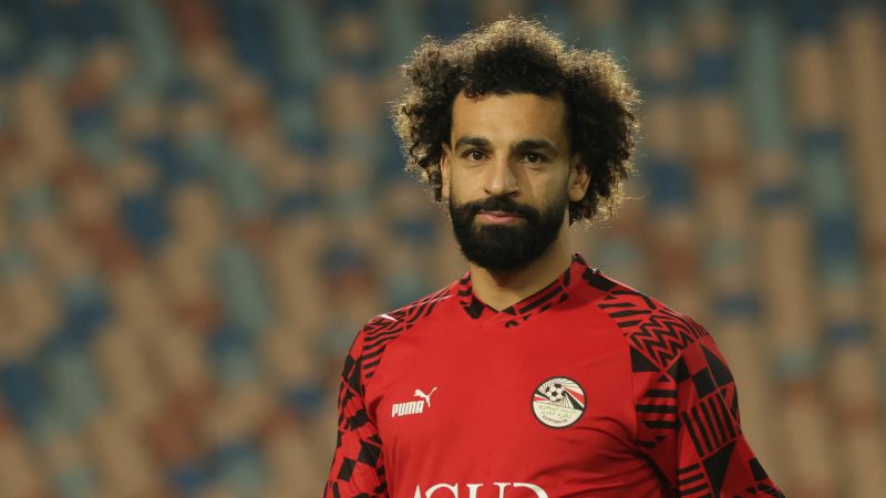 Mohamed Salah targeted by pitch invaders during Egypt match; escorted off by men in military uniforms