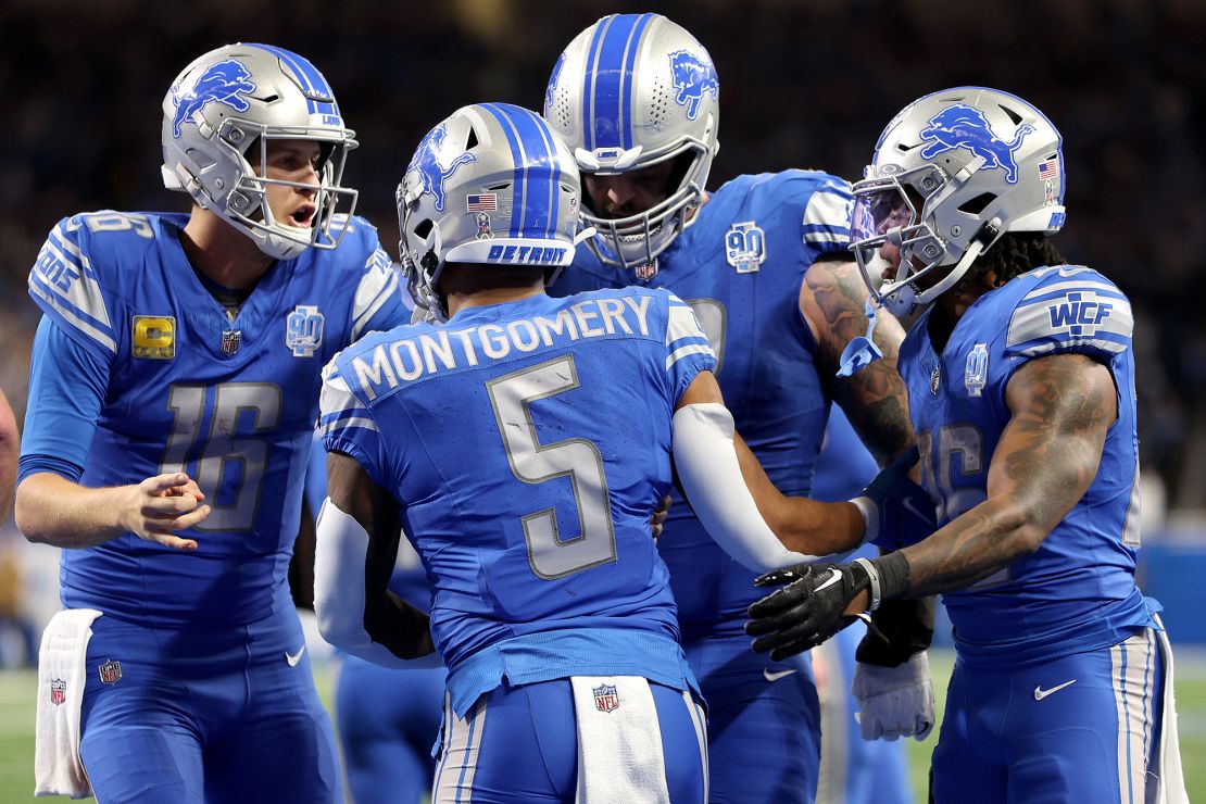 DETROIT, MICHIGAN - NOVEMBER 19: David Montgomery #5  celebrates a fourth quarter touchdown with Jared Goff #16 of the Detroit Lions during a game against the Chicago Bears at Ford Field on November 19, 2023 in Detroit, Michigan. (Photo by Gregory Shamus/Getty Images)