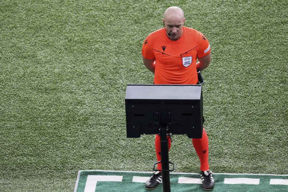 TOPSHOT - Polish referee Szymon Marciniak checks on a screen a potential penalty during the UEFA Champions League 1st round, day 5, Group F football match between Paris Saint-Germain (PSG) and Newcastle United on November 28, 2023 at the Parc des Princes stadium in Paris. (Photo by Alain JOCARD / AFP) (Photo by ALAIN JOCARD/AFP via Getty Images)