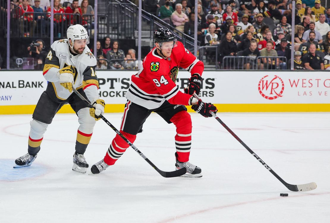 LAS VEGAS, NEVADA - OCTOBER 27: Corey Perry #94 of the Chicago Blackhawks tries to control the puck against Nicolas Hague #14 of the Vegas Golden Knights in the first period of their game at T-Mobile Arena on October 27, 2023 in Las Vegas, Nevada. The Blackhawks defeated the Golden Knights 4-3 in overtime. (Photo by Ethan Miller/Getty Images)