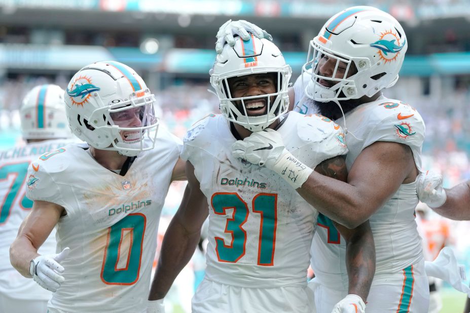 Miami Dolphins running back Raheem Mostert celebrates with teammates Braxton Berrios and Christian Wilkins after scoring one of his four touchdowns during the Dolphins' landslide victory over the Broncos on Sunday, September 24.