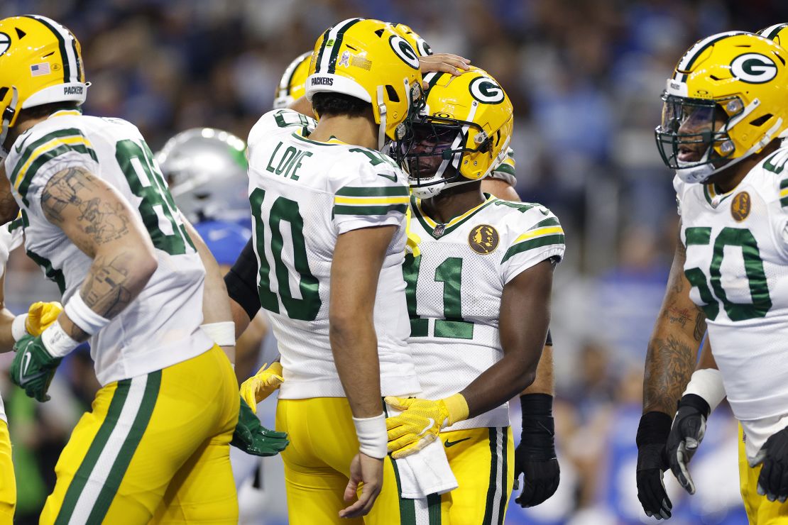 DETROIT, MICHIGAN - NOVEMBER 23: Jayden Reed #11 of the Green Bay Packers celebrates with Jordan Love #10 of the Green Bay Packers after scoring a touchdown against the Detroit Lions during the first quarter of the game at Ford Field on November 23, 2023 in Detroit, Michigan. (Photo by Mike Mulholland/Getty Images)