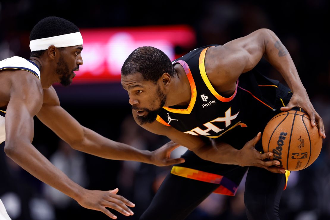 Justin Holiday #9 of the Denver Nuggets defends Kevin Durant #35 of the Phoenix Suns  during the second half at Footprint Center on December 01, 2023 in Phoenix, Arizona.