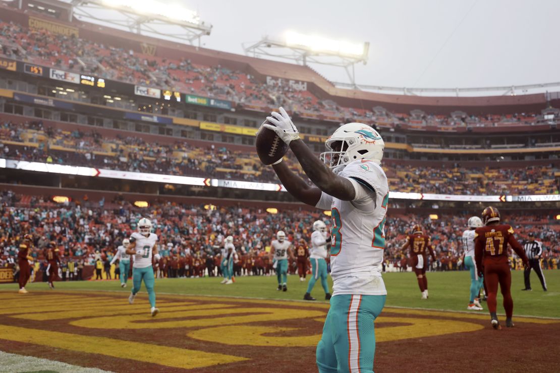 LANDOVER, MARYLAND - DECEMBER 03: De'Von Achane #28 of the Miami Dolphins celebrates after scoring a touchdown against the Washington Commanders during the fourth quarter at FedExField on December 03, 2023 in Landover, Maryland. (Photo by Rob Carr/Getty Images)