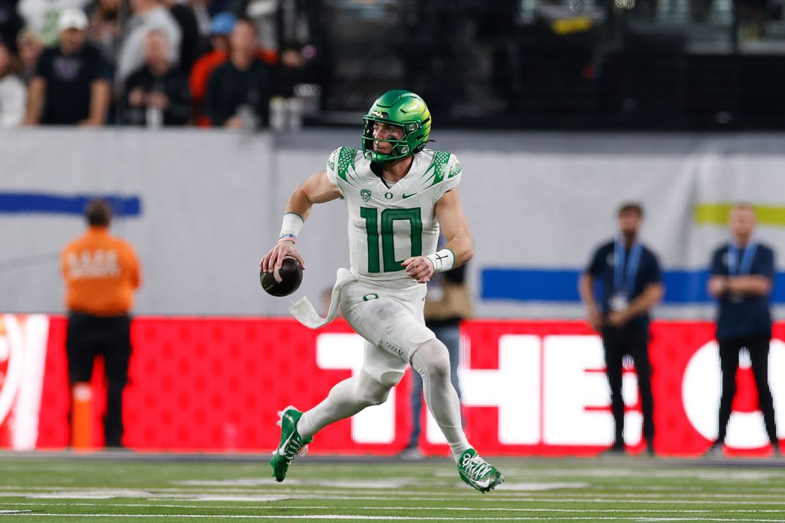 Oregon quarterback Bo Nix (10) scrambles during an NCAA college football game for the Pac-12 Conference championship against Washington, Friday, December 1, 2023, in Las Vegas.