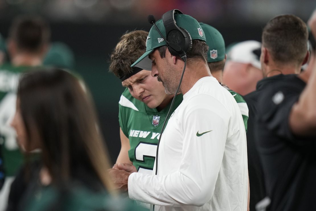 New York Jets quarterbacks Aaron Rodgers, right, and Zach Wilson talk during a preseason NFL football game against the Tampa Bay Buccaneers, Saturday, Aug. 19, 2023, in East Rutherford, N.J. (AP Photo/Seth Wenig)