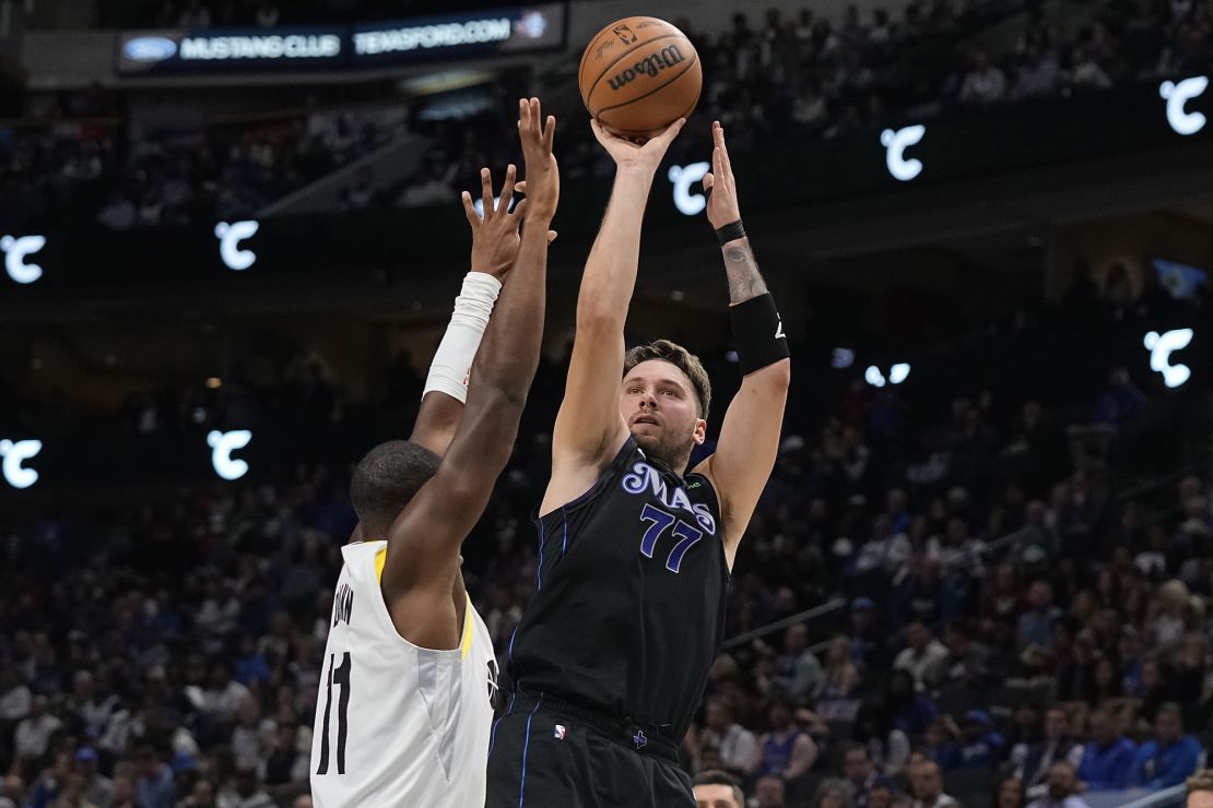 DALLAS, TEXAS - DECEMBER 06: Luka Doncic #77 of the Dallas Mavericks shoots as Kris Dunn #11 of the Utah Jazz defends during the first half at American Airlines Center on December 06, 2023 in Dallas, Texas. NOTE TO USER: User expressly acknowledges and agrees that, by downloading and/or using this Photograph, user is consenting to the terms and conditions of the Getty Images License Agreement. (Photo by Sam Hodde/Getty Images)