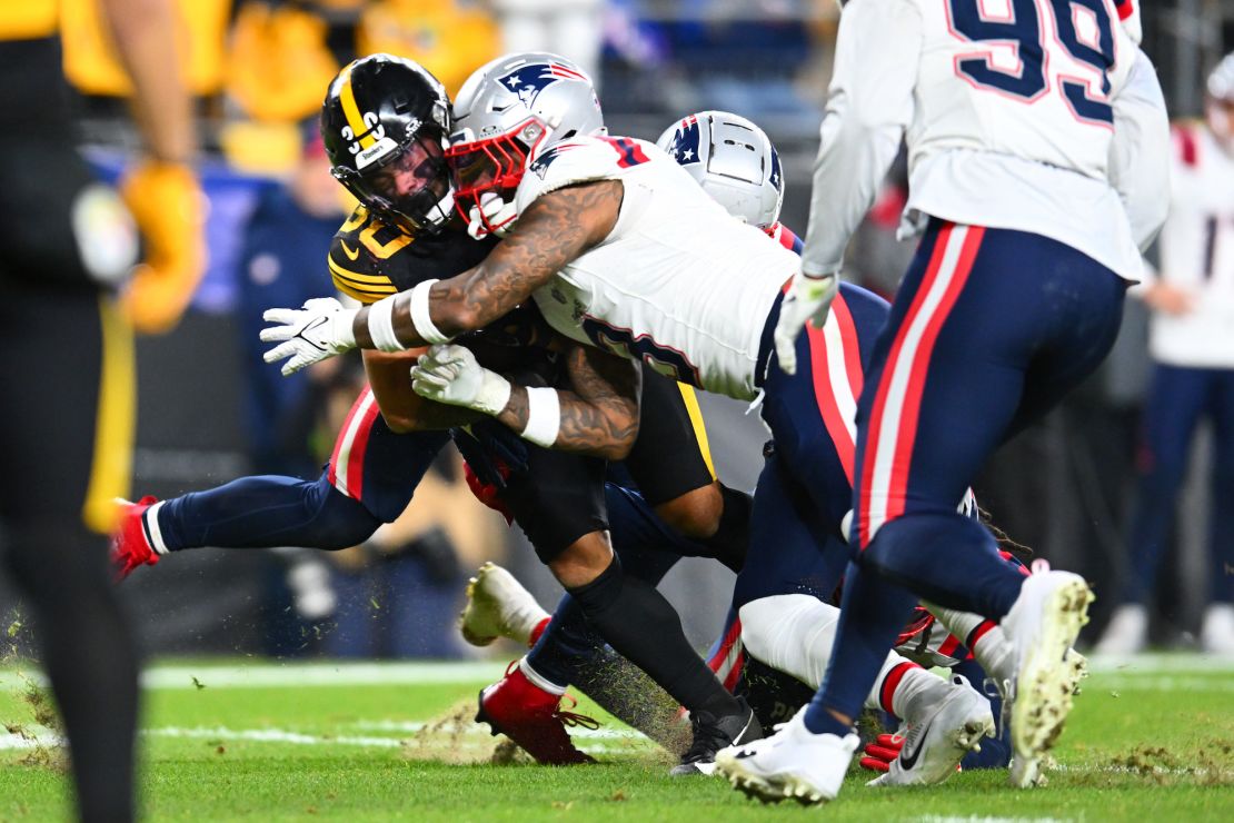 PITTSBURGH, PENNSYLVANIA - DECEMBER 07: Mack Wilson Sr. #3 of the New England Patriots and Jalen Mills #2 of the New England Patriots tackle Jaylen Warren #30 of the Pittsburgh Steelers on 4th down during the fourth quarter at Acrisure Stadium on December 07, 2023 in Pittsburgh, Pennsylvania. (Photo by Joe Sargent/Getty Images)