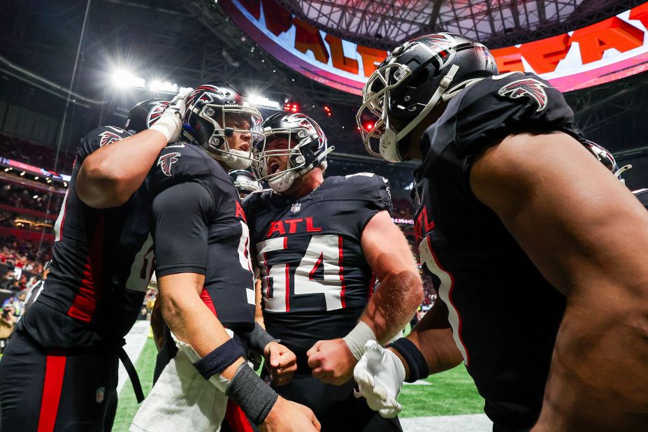 Atlanta Falcons quarterback Desmond Ridder celebrates with teammates after scoring a touchdown on December 10. The Falcons lost 29-25 to the Tampa Bay Buccaneers.