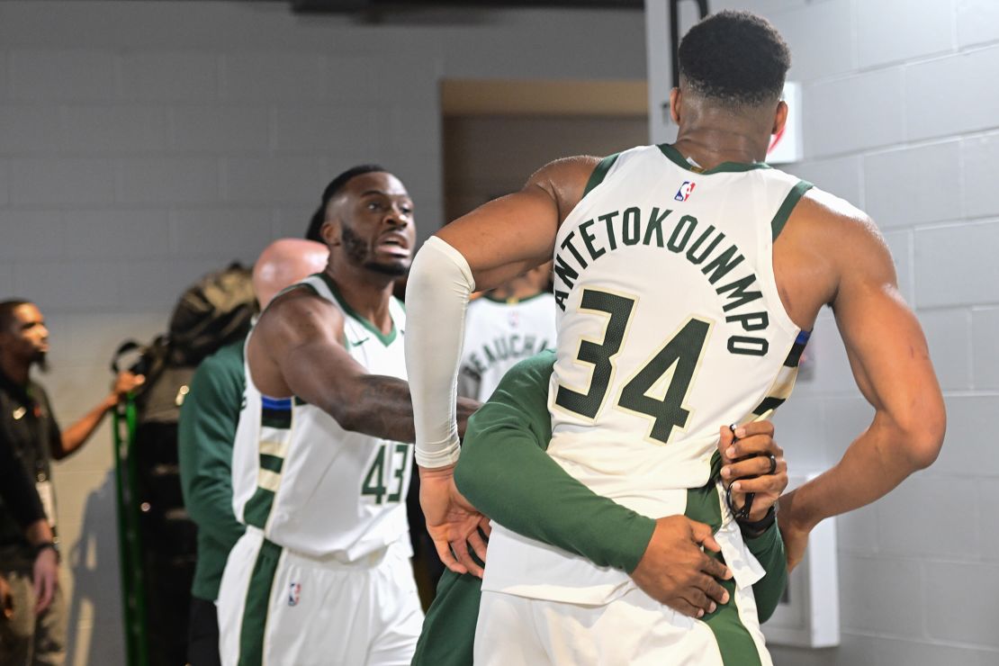 Dec 13, 2023; Milwaukee, Wisconsin, USA;  Milwaukee Bucks forward Giannis Antetokounmpo (34) is restrained by a coach outside the Indiana Pacers locker room after the game at Fiserv Forum. Mandatory Credit: Benny Sieu-USA TODAY Sports