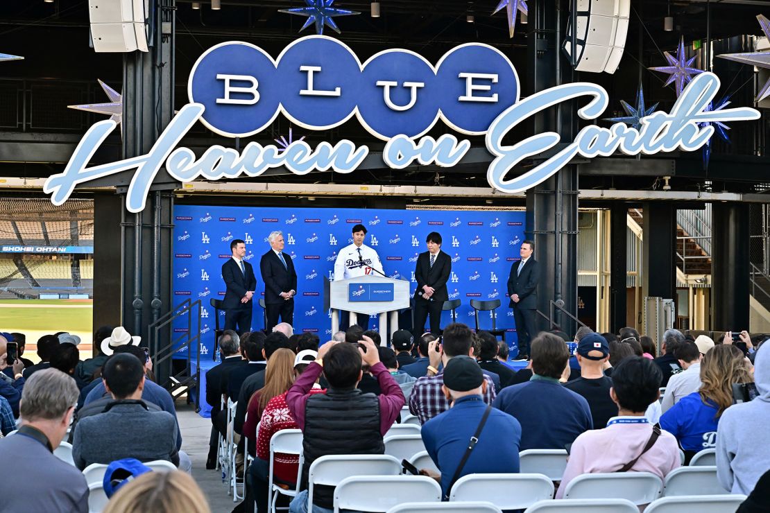 Japanese baseball player Shohei Ohtani (C) speaks during a press conference on his presentation after signing a ten-year deal with the Los Angeles Dodgers at Dodgers Stadium in Los Angeles, California on December 14, 2023. Ohtani has signed a record-shattering $700 million deal with the Los Angeles Dodgers, the richest in North American sports history. (Photo by Frederic J. Brown / AFP) (Photo by FREDERIC J. BROWN/AFP via Getty Images)