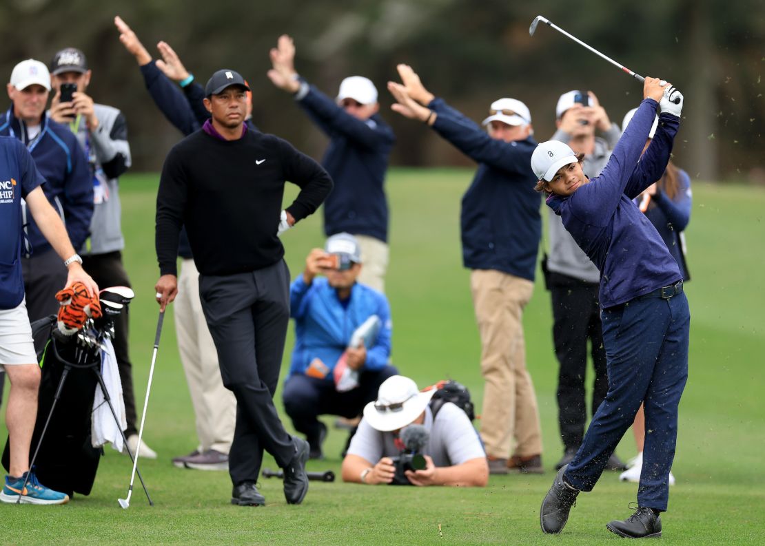 ORLANDO, FLORIDA - DECEMBER 15: Charl Woods of the United States plays his second shot on the 18th hole watched by his father Tiger Woods during the Friday pro-am as a preview for the PNC Championship at The Ritz-Carlton Golf Club on December 15, 2023 in Orlando, Florida. (Photo by David Cannon/Getty Images)