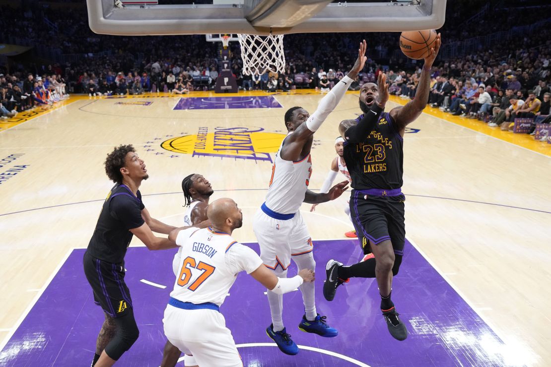 Dec 18, 2023; Los Angeles, California, USA; Los Angeles Lakers forward LeBron James (23) shoots the ball against New York Knicks forward Julius Randle (30) in the first half at Crypto.com Arena. Mandatory Credit: Kirby Lee-USA TODAY Sports